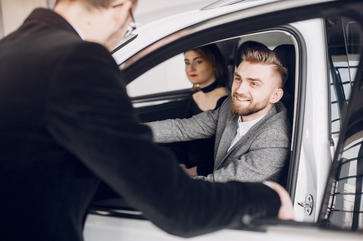 A passenger sitting in the front seat of a Luxury UAE Cars