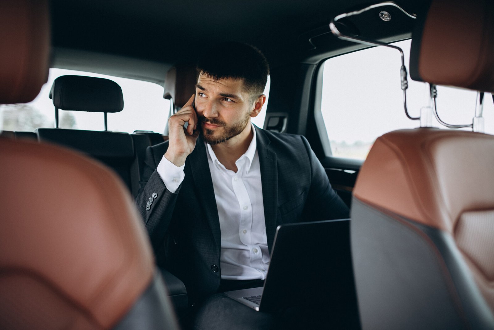 handsome business man working computer car scaled